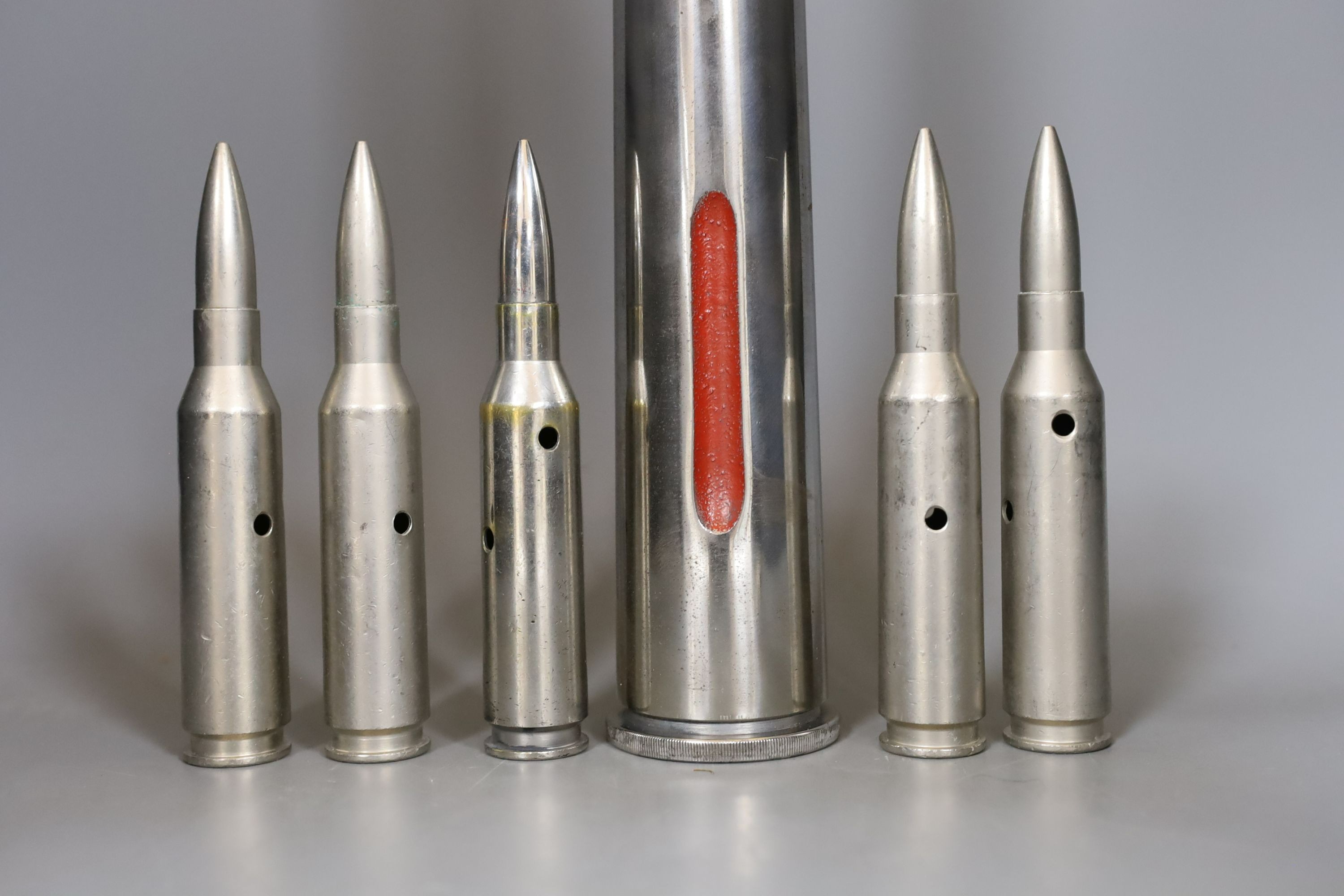 Polished steel military training round and five 50 calibre rounds